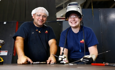 2 workers smiling at camera