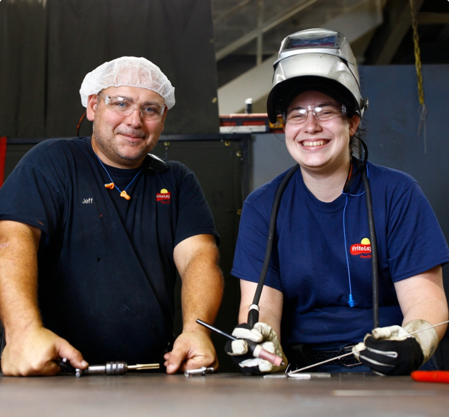 2 workers smiling at camera